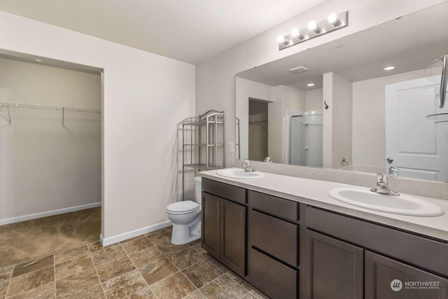 bathroom with vanity, an enclosed shower, and toilet