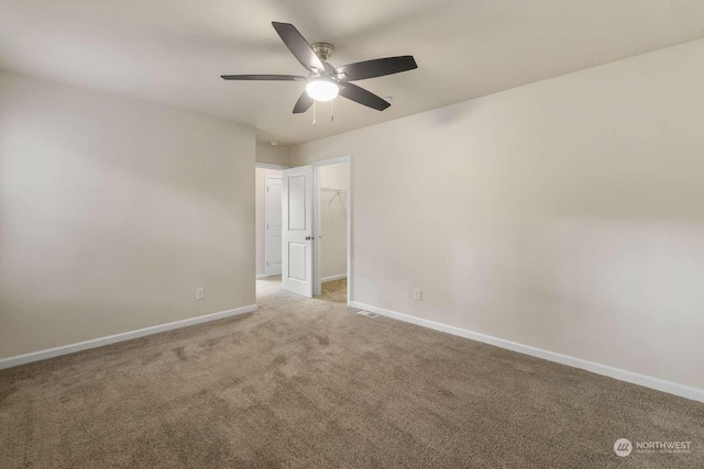 spare room with carpet floors and ceiling fan