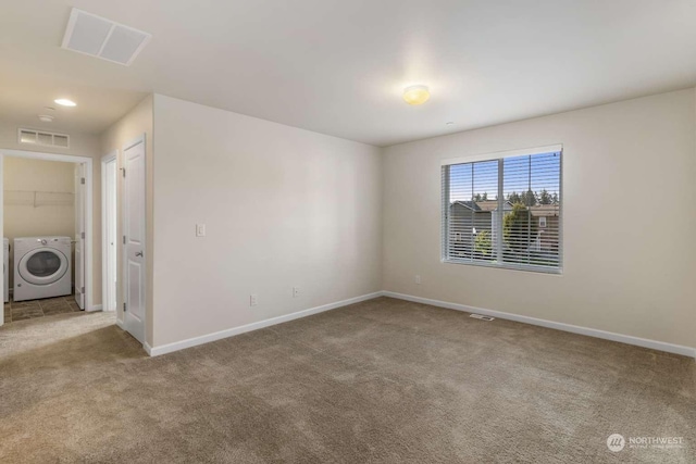 unfurnished room with light carpet and washer and clothes dryer