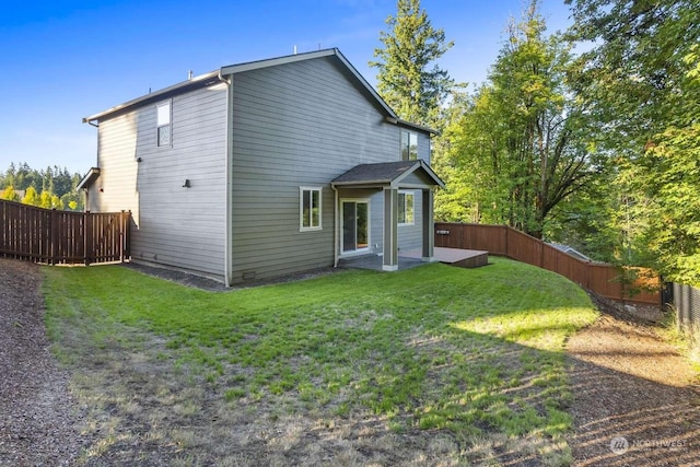 rear view of property with a lawn