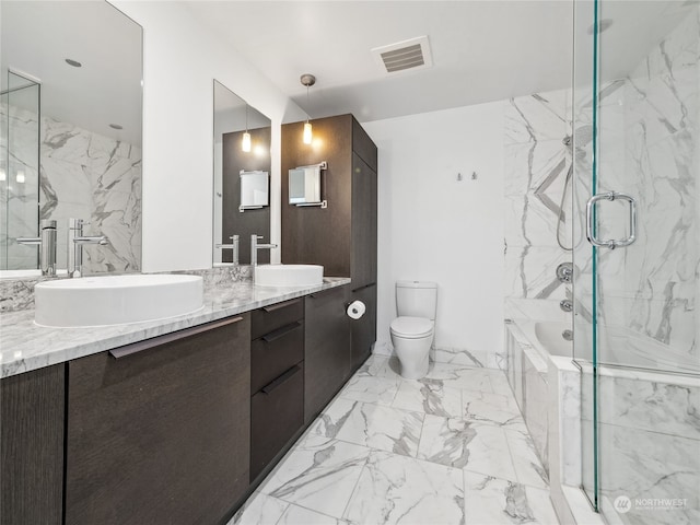 full bathroom featuring vanity, toilet, and separate shower and tub