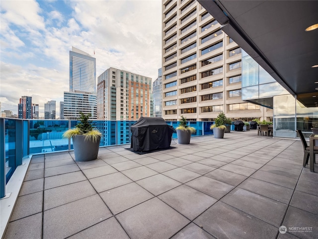 view of patio with grilling area and a balcony