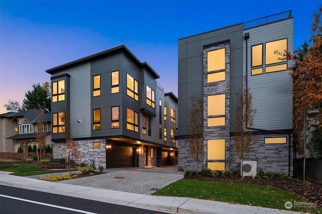 modern home featuring ac unit and a garage