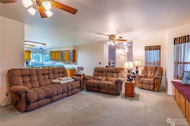 carpeted living room with ceiling fan