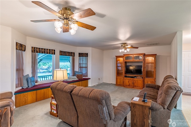 carpeted living room with ceiling fan