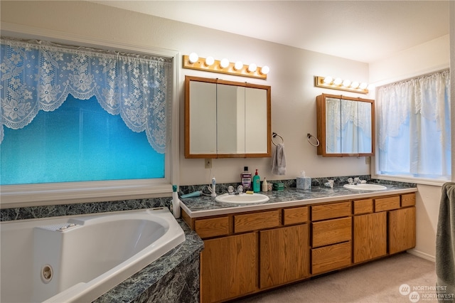 bathroom featuring vanity and tiled tub