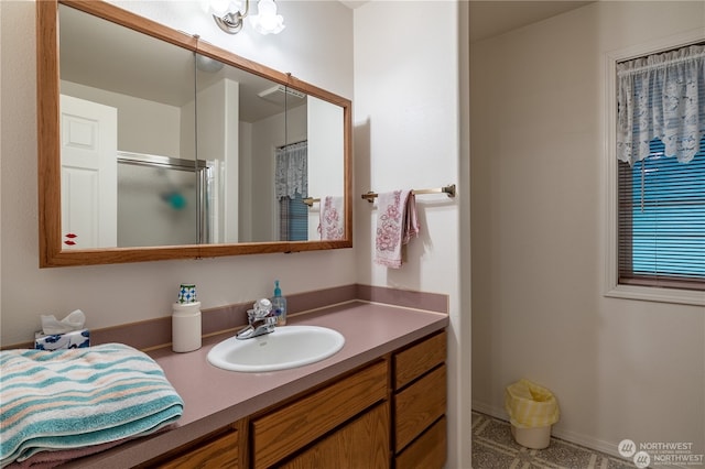 bathroom featuring vanity and an enclosed shower