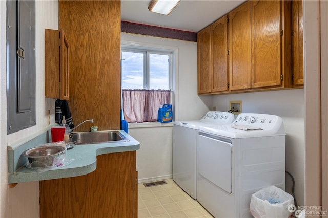 laundry area featuring cabinets, sink, and separate washer and dryer