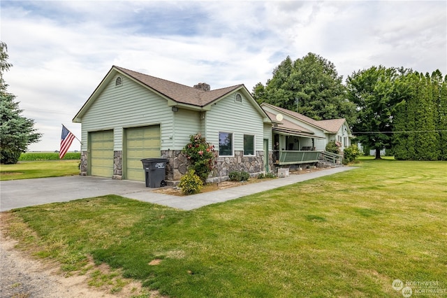 view of front of property featuring a garage and a front lawn