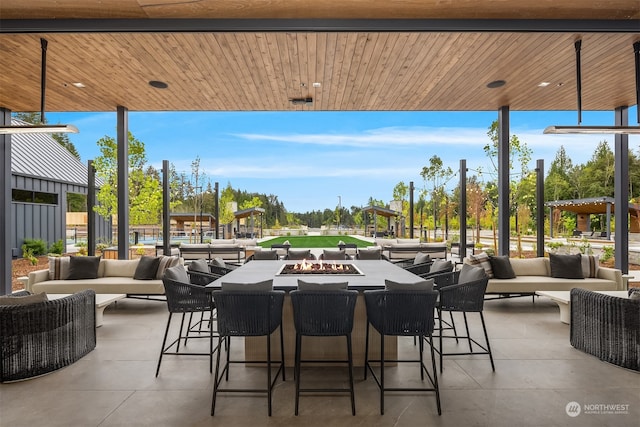 view of patio featuring an outdoor living space with a fire pit