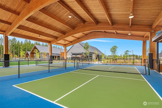 view of tennis court featuring basketball hoop