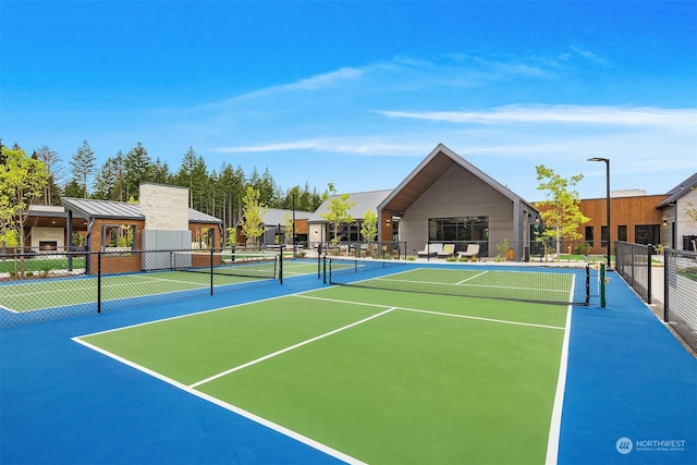 view of tennis court with basketball hoop