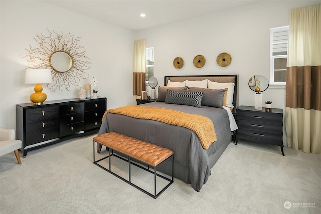 carpeted bedroom featuring multiple windows