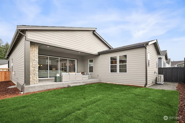 back of property featuring a lawn and a patio area