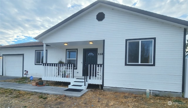 view of front facade with a garage and a porch