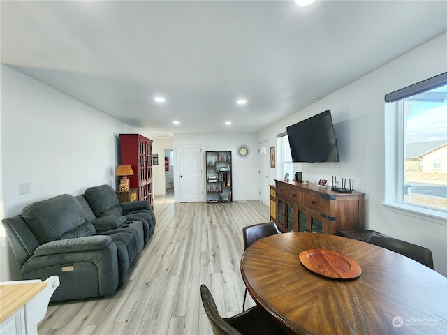 living room with a wealth of natural light and light wood-type flooring