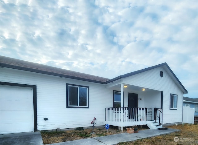 ranch-style home featuring a garage and a porch