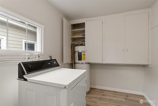 laundry area with cabinets, water heater, light hardwood / wood-style floors, and washer / clothes dryer