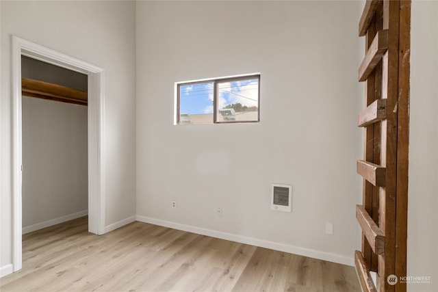 unfurnished bedroom with a closet and light wood-type flooring