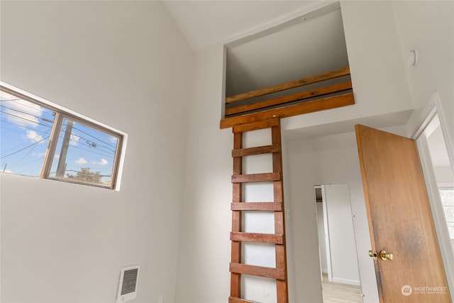 stairs with hardwood / wood-style flooring