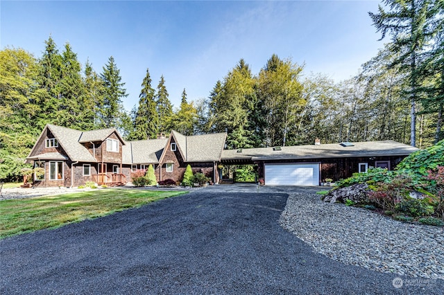 view of front of home featuring a carport, a front yard, and a garage