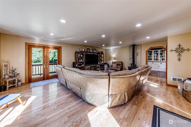 107 Dowans Creek Rd, Forks, WA 98331 - living room with a wood stove, light wood-style flooring, and recessed lighting