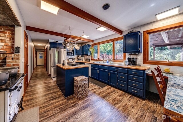 107 Dowans Creek Rd, Forks, WA 98331 - kitchen with blue cabinetry, butcher block countertops, dark wood finished floors, stainless steel appliances, and a center island
