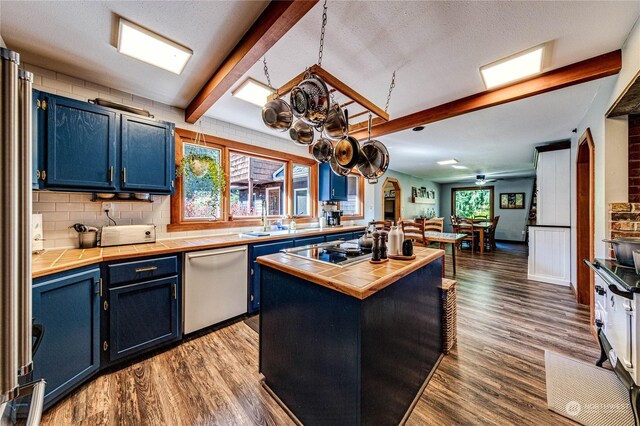 107 Dowans Creek Rd, Forks, WA 98331 - kitchen with tile countertops, stainless steel dishwasher, blue cabinetry, dark wood finished floors, and beam ceiling