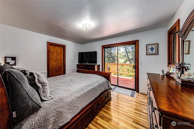 bedroom with light hardwood / wood-style floors and access to exterior