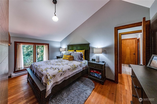 107 Dowans Creek Rd, Forks, WA 98331 - bedroom with vaulted ceiling, a baseboard heating unit, wood finished floors, and baseboards