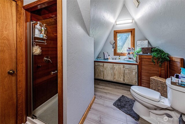 107 Dowans Creek Rd, Forks, WA 98331 - full bath with a textured wall, toilet, vanity, a stall shower, and wood finished floors