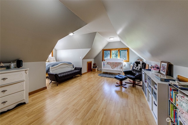 bedroom featuring vaulted ceiling and light hardwood / wood-style floors