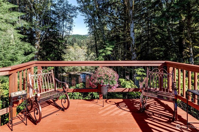 107 Dowans Creek Rd, Forks, WA 98331 - wooden deck with a wooded view