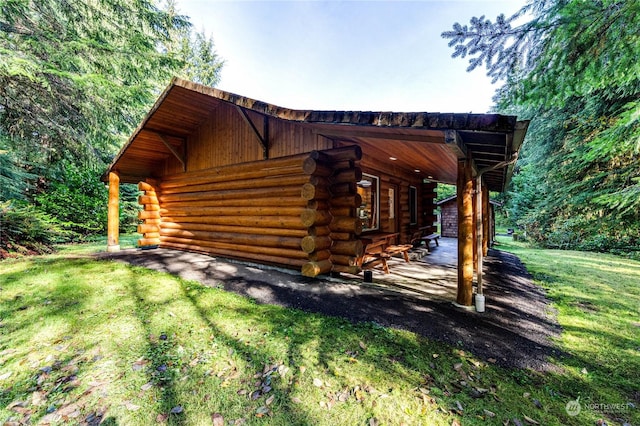 107 Dowans Creek Rd, Forks, WA 98331 - view of home's exterior with log exterior and a yard