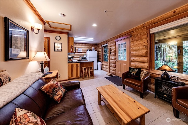 living room featuring log walls and light tile patterned floors