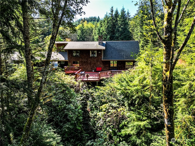 rear view of house with a wooden deck