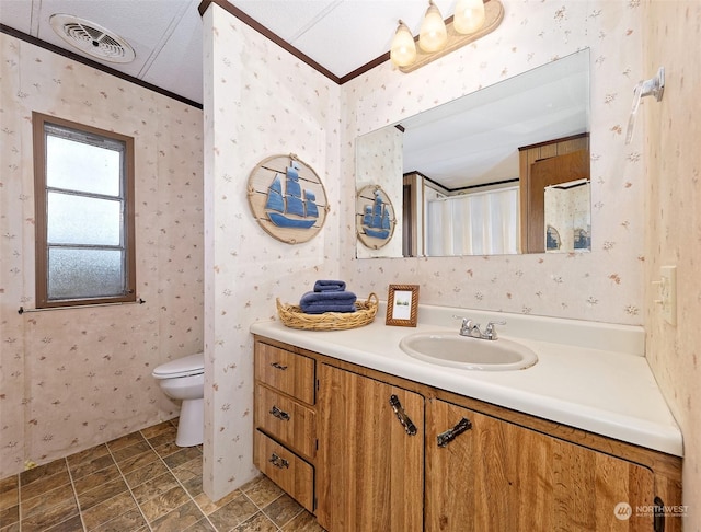 bathroom featuring ornamental molding, wallpapered walls, and visible vents