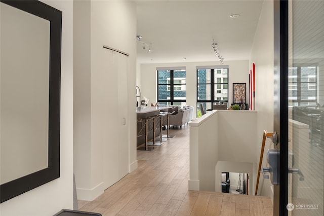 corridor featuring light hardwood / wood-style floors