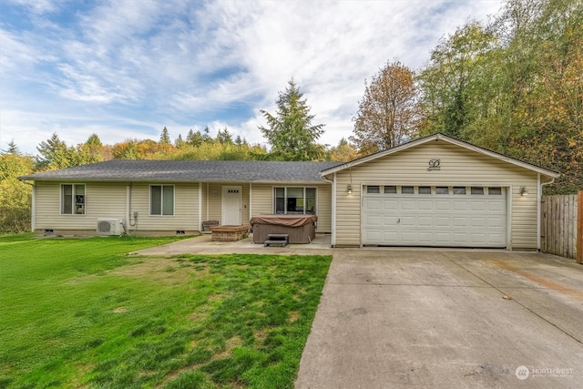 ranch-style home with a hot tub, a front yard, and a garage