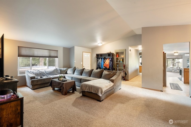 carpeted living room featuring vaulted ceiling