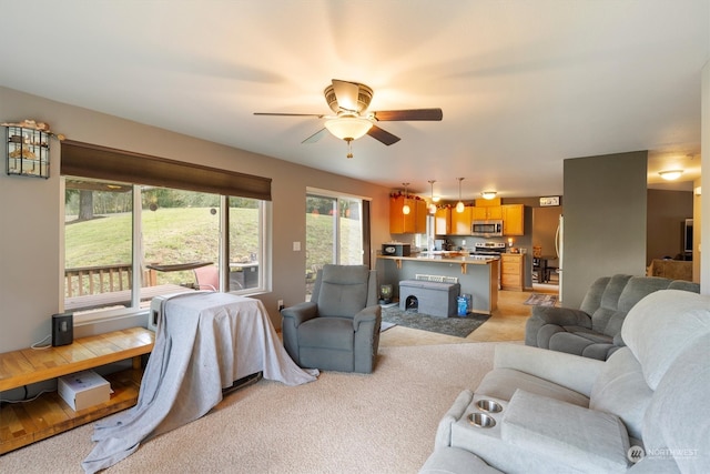 carpeted living room with ceiling fan