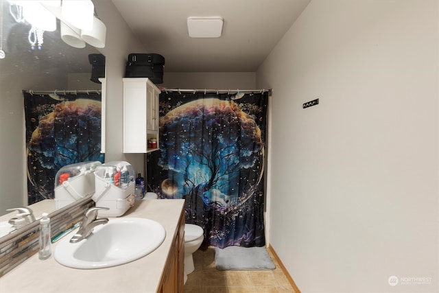 bathroom with vanity, toilet, and tile patterned floors