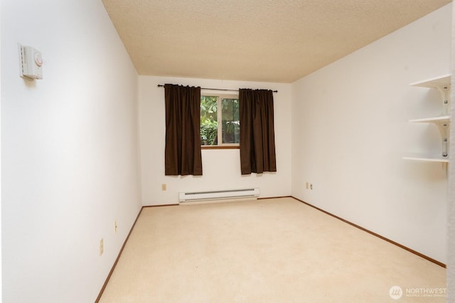 carpeted spare room featuring baseboards, baseboard heating, and a textured ceiling