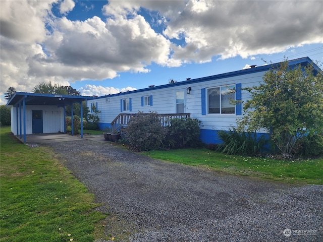 view of front facade featuring a front lawn and a carport