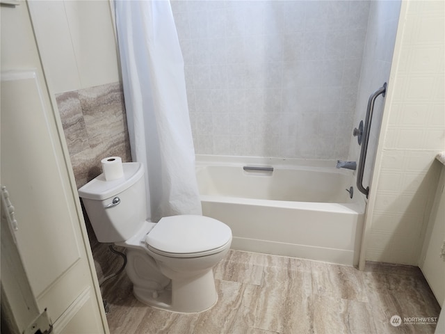 bathroom featuring toilet, shower / bathtub combination with curtain, and wood-type flooring