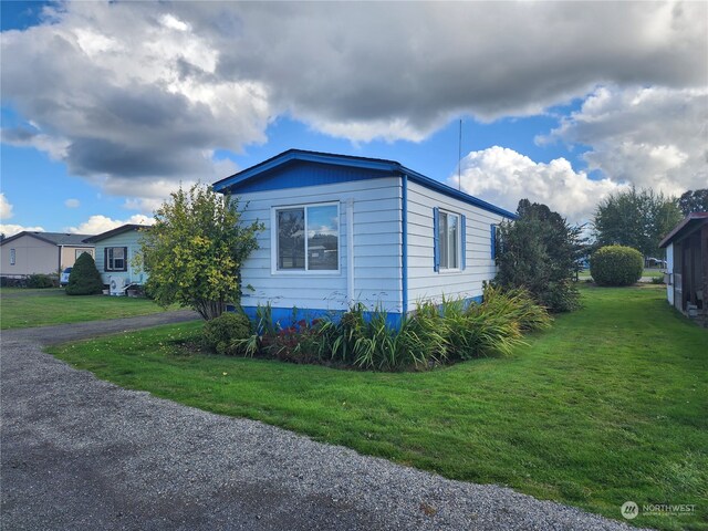 view of home's exterior featuring a lawn