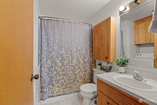 bathroom with washer / dryer, vanity, and toilet