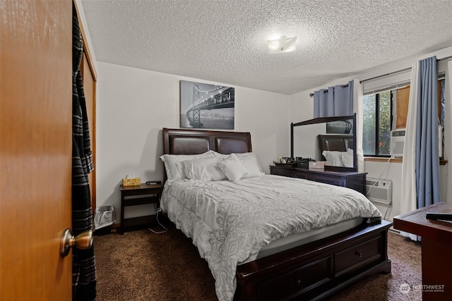 bedroom with a closet, a textured ceiling, cooling unit, and dark carpet