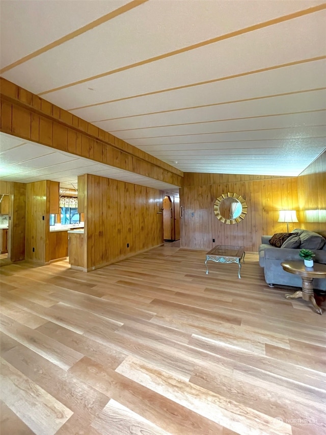 unfurnished living room featuring wood walls and wood-type flooring