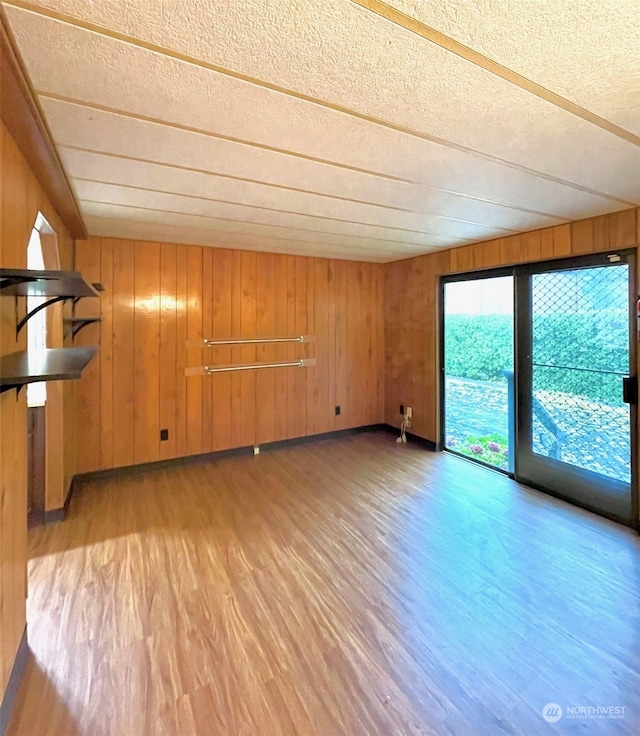 interior space featuring light hardwood / wood-style floors and wood walls